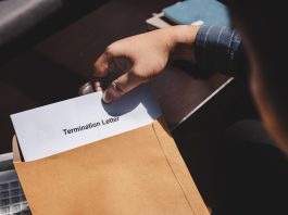 Termination of Employment and layoff concept, Stressed businessman feeling down after received Termination of Employment Form in paper brown envelope.