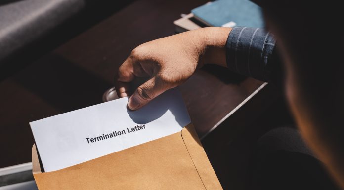 Why employers should have contracts for non-unionized workers Termination of Employment and layoff concept, Stressed businessman feeling down after received Termination of Employment Form in paper brown envelope.