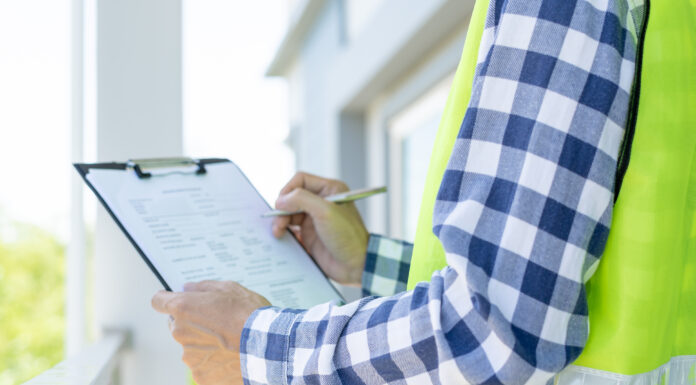 What’s new and exciting at Tarion and HCRA? inspector or engineer is inspecting construction and quality assurance new house using a checklist. Engineers or architects or contactor work to build the house before handing it over to the homeowner