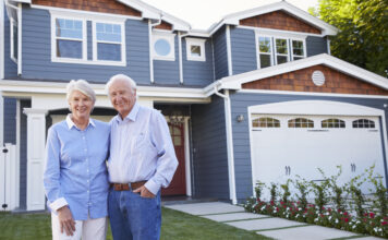 Building for the 60-plus market: The key to unlocking the housing ladder Portrait Of Senior Couple Standing Outside House