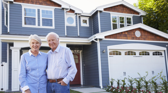 Building for the 60-plus market: The key to unlocking the housing ladder Portrait Of Senior Couple Standing Outside House